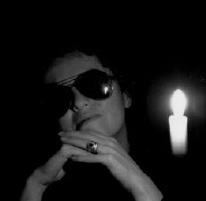 Thumbnail of lady wearing sunglasses light only by candle